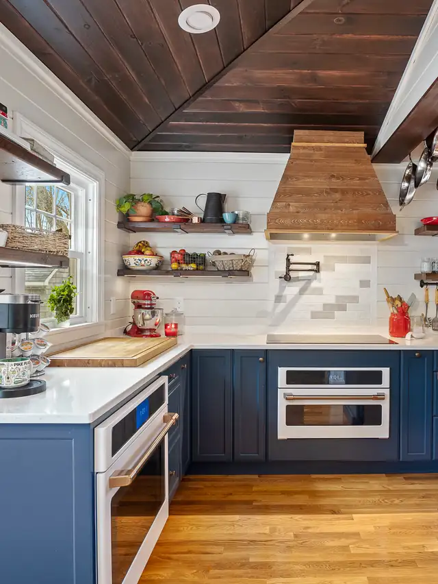Bristol, RI kitchen with navy lower cabinets, a wood plank ceiling, a wood range hood and open shelves on white tile